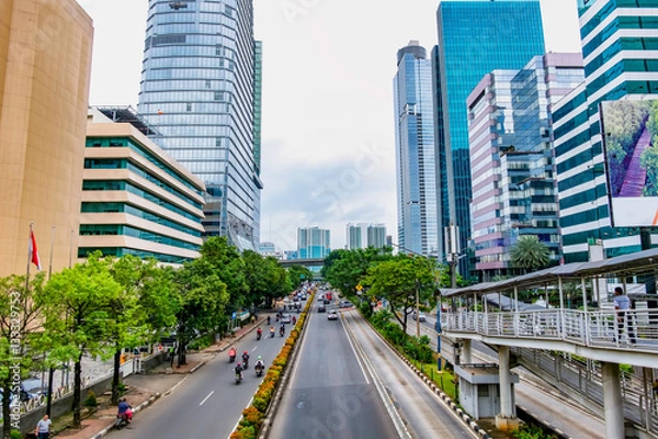 Fototapeta Photo of big road in Jakarta and its traffic, with skyscraper buildings in the both side of the road. Captured in Rasuna Said Street, Indonesia.