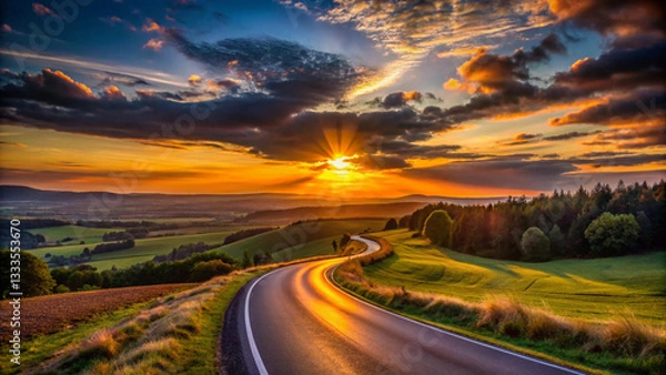 Obraz Sunset over the dark and worrier road at evening, landscape background.