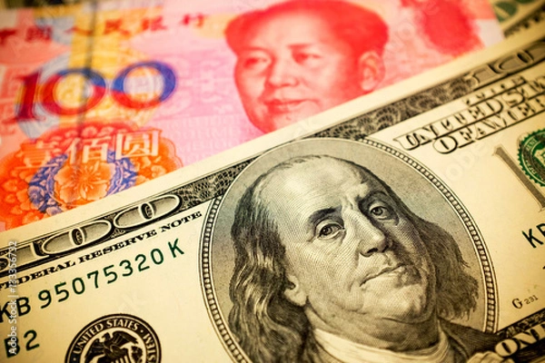 Fototapeta Chinese Yuan Note and U.S. dollar background  (Exchange rate concept)