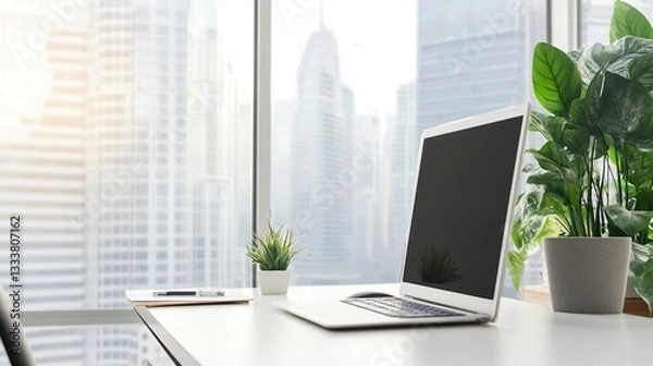 Obraz Minimalist office desk with natural light, blurred cityscape outside; simplicity and focus in a modern workspace.
