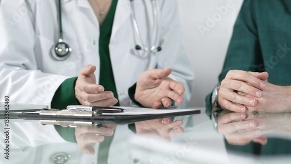 Fototapeta Doctor using hand gestures to explain diagnosis to patient during medical consultation, providing support and guidance for healthcare decisions