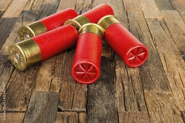 Fototapeta 12 gauge red hunting cartridges for shotgun on wooden background. Macro shot.