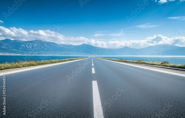 Fototapeta  wideangle shot of empty highway stretching into horizon under cloudy sky Road Concept