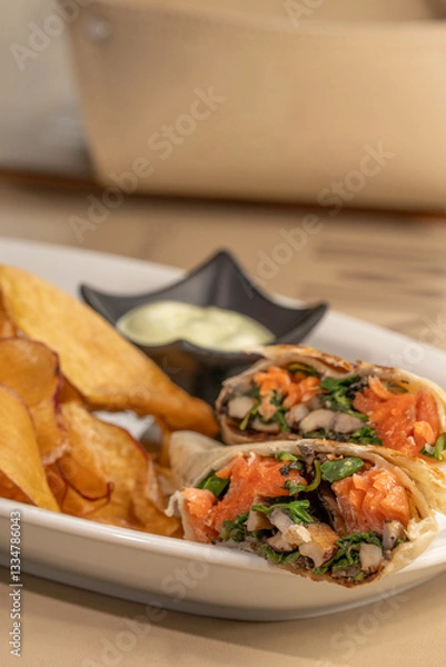 Obraz Chicken and salmon sandwich wraps without tac on a plate with sweet potatoes and guacamole sauce