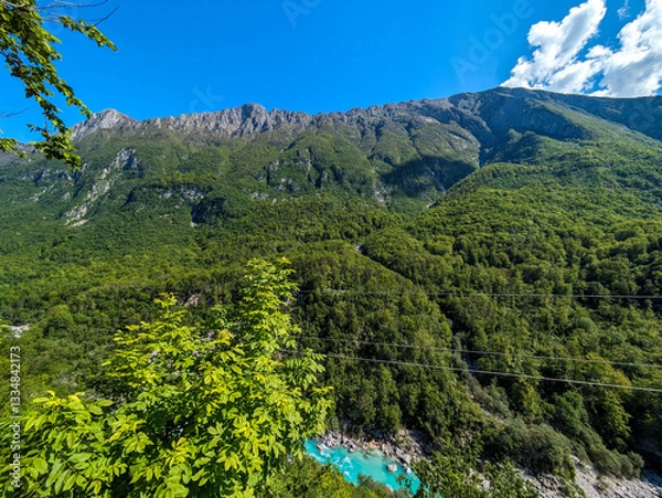 Obraz Soca Valley, Slovenia – Aerial view of the emerald-green Alpine River Soca on a bright sunny summer day with green foliage..The last wild river in Europe in Triglav National Park near the Vricic Pass