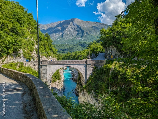 Obraz Soca Valley, Slovenia – Aerial view of the emerald-green Alpine River Soca on a bright sunny summer day with green foliage..The last wild river in Europe in Triglav National Park near the Vricic Pass