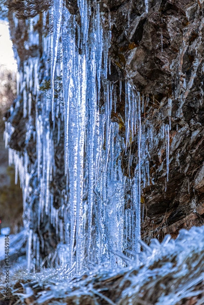 Fototapeta Cold natural sculptures. The same limestone formations we find in caves can be found in the form of ice in runoff from mountain slopes in winter.