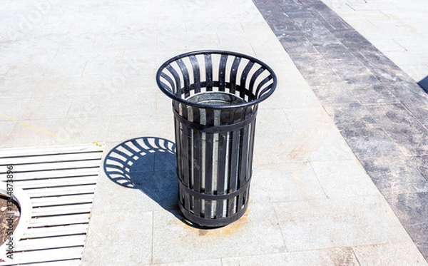 Fototapeta Garbage metal container for waste and trash at the city street