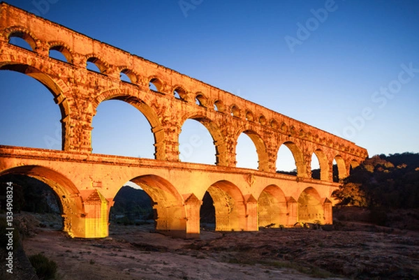 Obraz Pont du Gard, ancient Roman aqueduct bridge, colorful projection mapping video show, under Provence starry night sky, Gorges du Gardon, natural landscape designated Biosphere Reserve by UNESCO, France