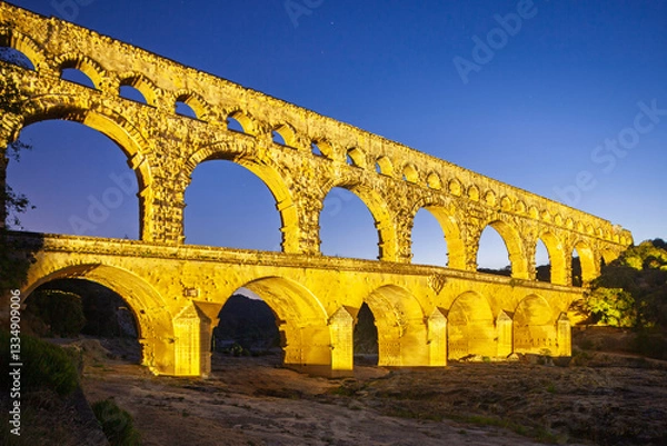 Obraz Pont du Gard, ancient Roman aqueduct bridge, colorful projection mapping video show, under Provence starry night sky, Gorges du Gardon, natural landscape designated Biosphere Reserve by UNESCO, France