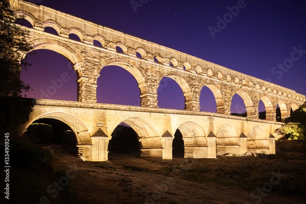 Obraz Pont du Gard, ancient Roman aqueduct bridge, colorful projection mapping video show, under Provence starry night sky, Gorges du Gardon, natural landscape designated Biosphere Reserve by UNESCO, France