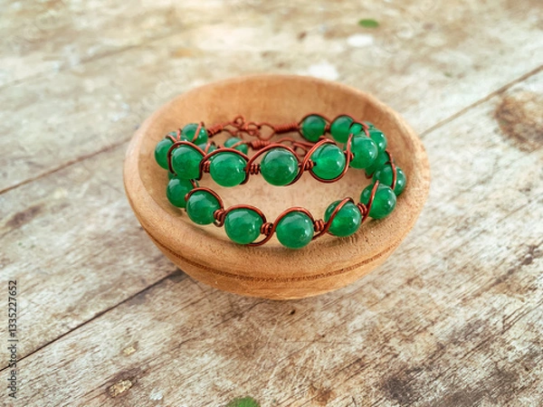 Obraz handmade wire copper bracelet on wooden table