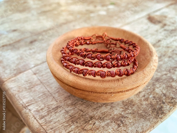 Obraz handmade wire copper bracelet on wooden table