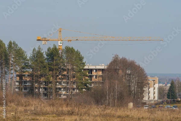 Fototapeta a large crane working on a new block