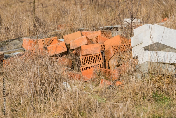 Fototapeta a pile of bricks in a field