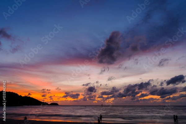 Obraz Sunset over the water with clouds against the sunlight on the Andaman Sea, Patong, Phuket, Thailand.