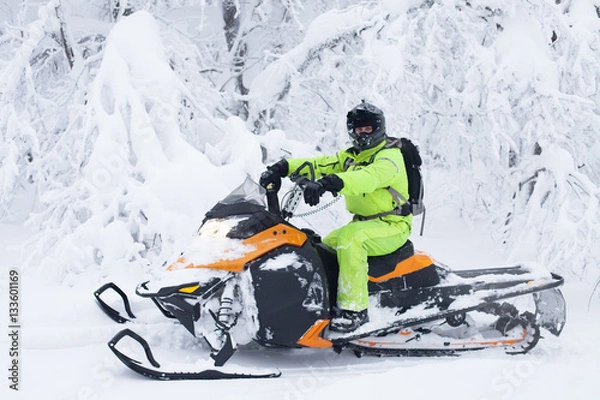 Obraz Man driving snowmobile