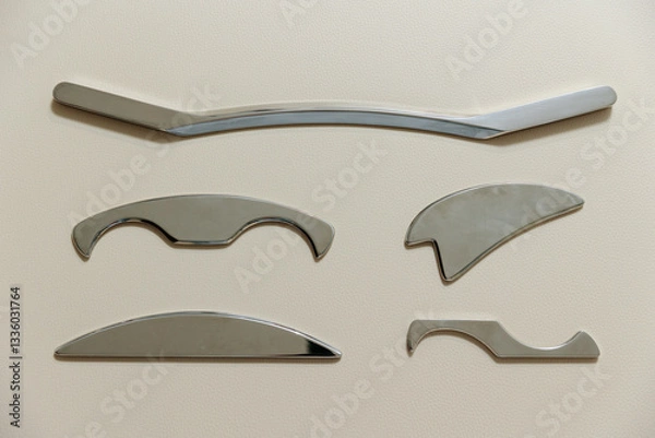 Fototapeta Intelligent stainless steel IASTM instruments for soft tissue massage and pain relief, the instruments lie on a beige massage table