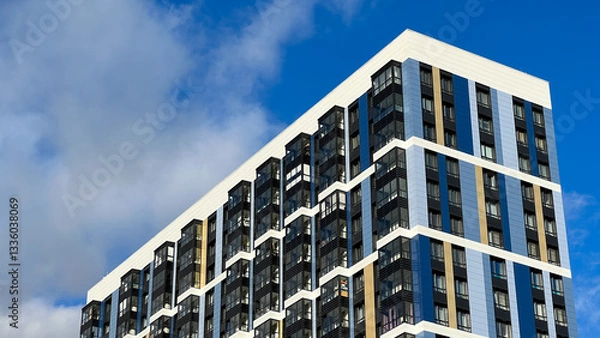 Fototapeta The facade of the building is purple,geometric patterns from windows and balconies, the colored wall of a modern multi-storey residential building, the abstract texture of the facade of the house