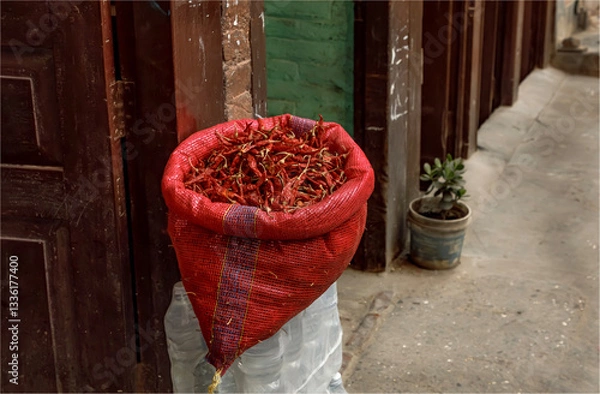 Obraz A sack of dried  red chillies for sale on a doorstep