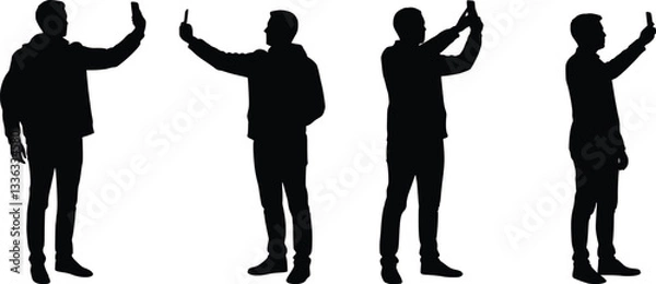 Fototapeta Black silhouette of people standing and taking a selfie with a smartphone, holding it in the right hand, extended outward, and looking at the screen