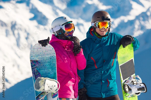 Obraz Happy couple of snowboarders in the alpine mountains