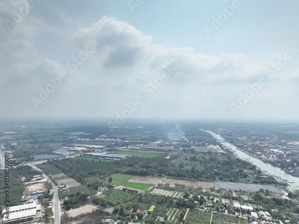 Obraz The River's Embrace: An Aerial Glimpse of little town Urban Heart. This drone photograph captures a wide aerial view of Nakhon Pathom, Thailand, with a focus on the river that flows through town