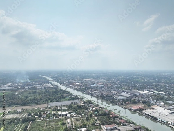 Obraz The River's Embrace: An Aerial Glimpse of little town Urban Heart. This drone photograph captures a wide aerial view of Nakhon Pathom, Thailand, with a focus on the river that flows through town
