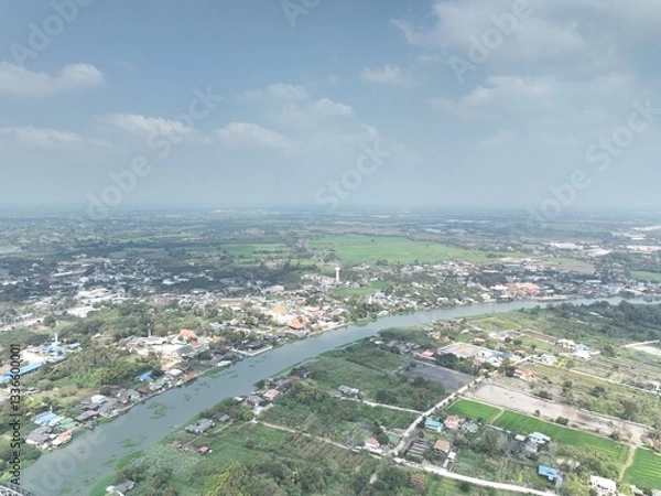 Obraz The River's Embrace: An Aerial Glimpse of little town Urban Heart. This drone photograph captures a wide aerial view of Nakhon Pathom, Thailand, with a focus on the river that flows through town