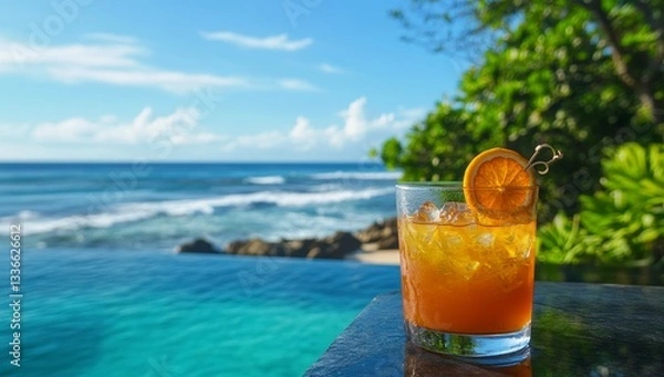 Fototapeta Refreshing orange cocktail by the ocean