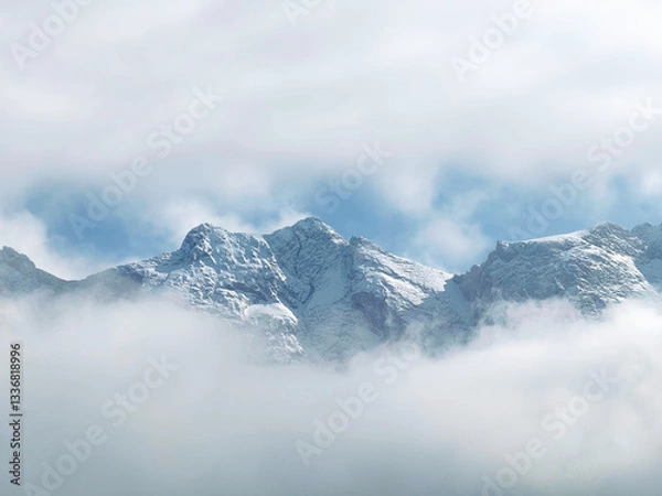 Fototapeta Scenic view of snowcapped Zugspitze mountain range  visible through a gap in the clouds