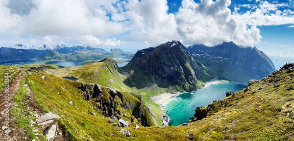 Fototapeta Panoramic view on the Lofoten mountains in Norway with two sandy bays in the foreground and multiple mountains, lakes and the sea in the background