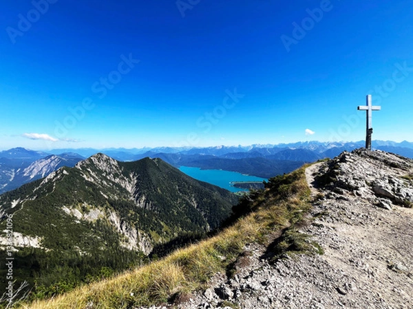 Fototapeta Scenic view of the summit cross with the German alps and a lake in the background