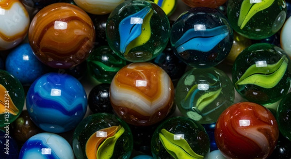 Fototapeta A close up shot of many colorful glass marbles with unique patterns and designs filling the frame well