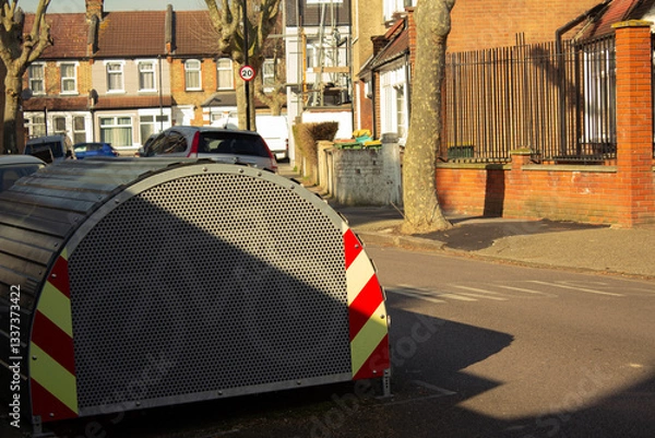 Fototapeta A bicycle storage shed in the middle of the street.