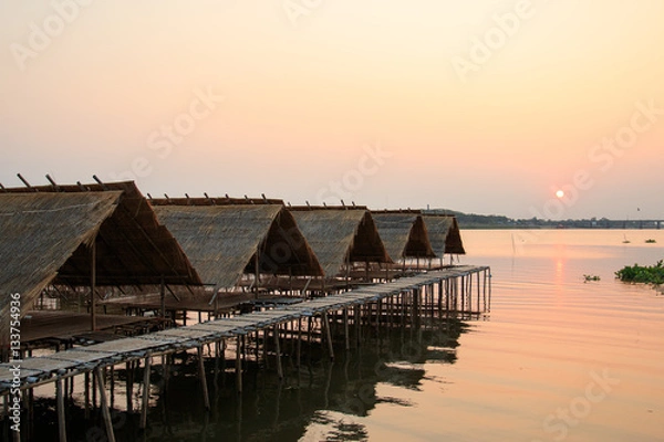 Obraz Huts over water with sunset