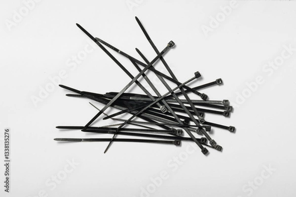 Obraz Collection of black cable ties scattered on a flat surface