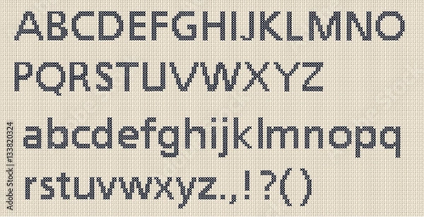Fototapeta Cross stitch sewn lettering with a frabric texture on a piece of cross-stitch material