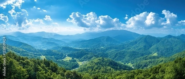 Fototapeta Serene vista of lush green mountains under a bright blue sky with fluffy white clouds panoramic view