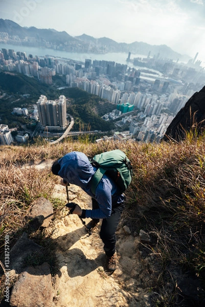 Fototapeta Hiker climbing up on the mountain trail in Hong Kong
