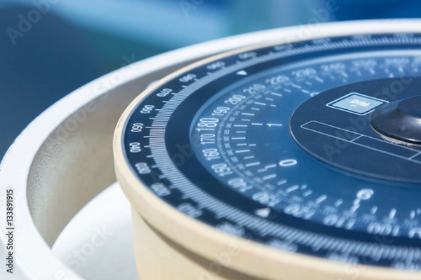 Obraz Compass aboard large ship on a blue summer sea.