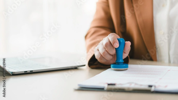 Fototapeta Approval and certification concept. Professional stamping documents for official verification, compliance, business authorization, legal validation, contract approval, and administrative paperwork.