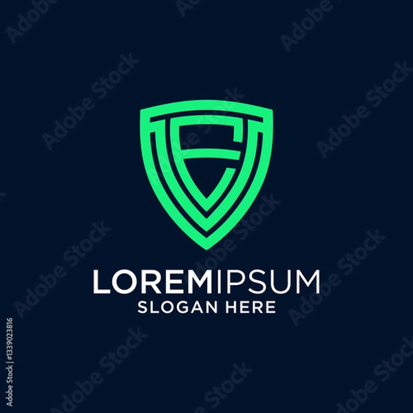 Fototapeta Modern Green Letter E Logo Shield on Dark Blue Background