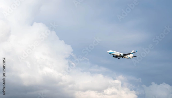 Fototapeta A passenger plane prepares for landing by opening its landing gear