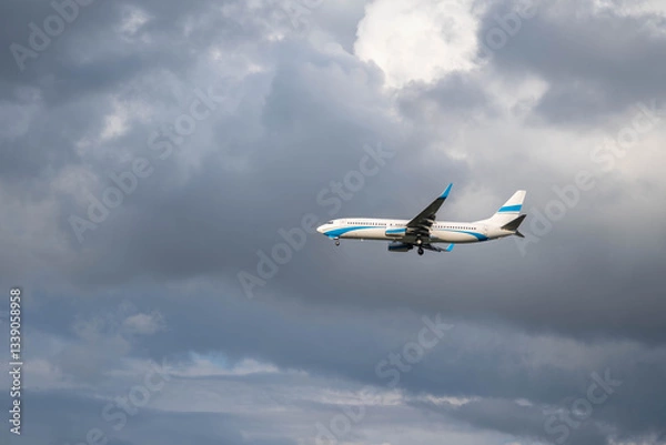 Obraz A passenger plane prepares for landing by opening its landing gear