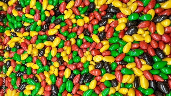 Fototapeta Nuts in multi-colored chocolate glaze are lying in bulk.