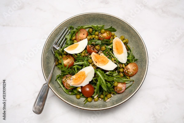 Fototapeta A vibrant and colorful salad featuring fresh greens arugula, diced tomatoes, sweet peas, and softboiled eggs cooked perfectly.