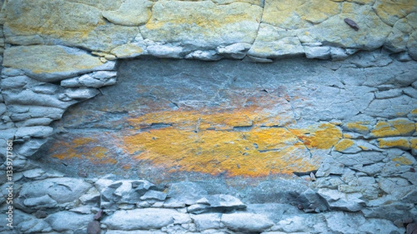 Fototapeta Close-up of a textured rock surface with layers of cracked stone. 