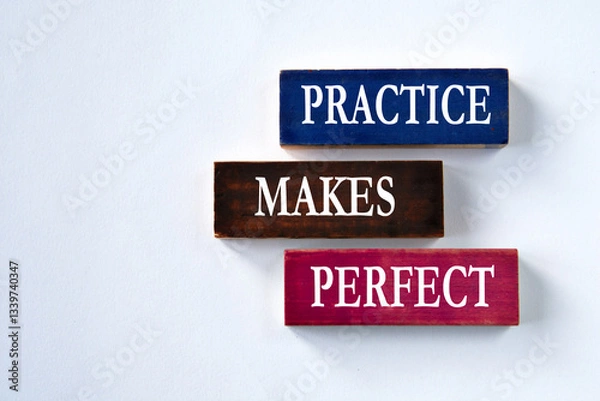 Fototapeta PRACTICE MAKES PERFECT - words on colorful wooden blocks on a grey background