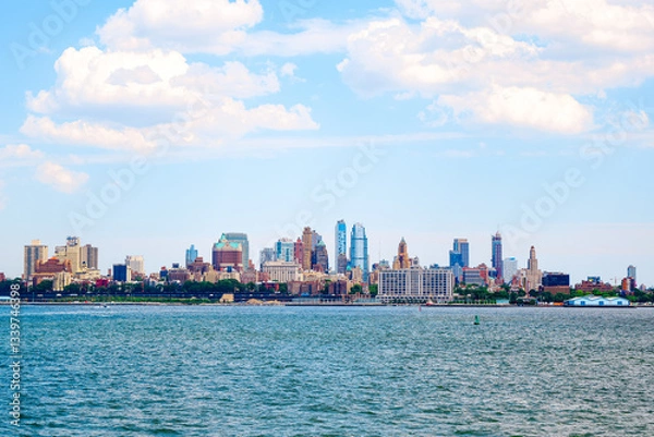 Fototapeta Manhattan skyline in New York United States. Distant view of New York city skyline cruising in Battery Park. USA, NYC, NY, Manhattan. Large big city of buildings across the sea. Manhattan skyline.